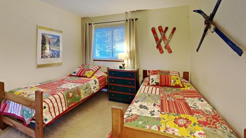 a bedroom with two beds and a window at 205-F Buffalo Ridge in Silverthorne