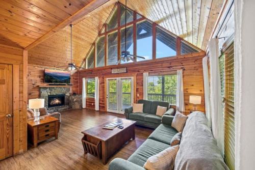 a living room with a couch and a fireplace at Misty Mountain Game Room and Hot Tub in Pigeon Forge