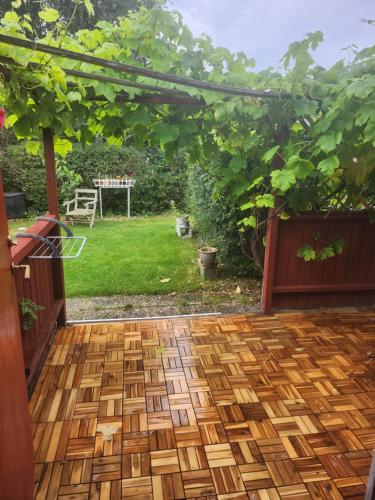 an outdoor patio with a pergola and a yard at Holiday home with garden in Helsingborg