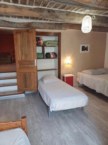 a bedroom with two beds and a cabinet in it at Gîte les Granges dans ferme provençale. 14 pers in Ongles
