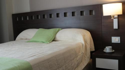 Ένα ή περισσότερα κρεβάτια σε δωμάτιο στο Days Inn & Suites by Wyndham La Plata