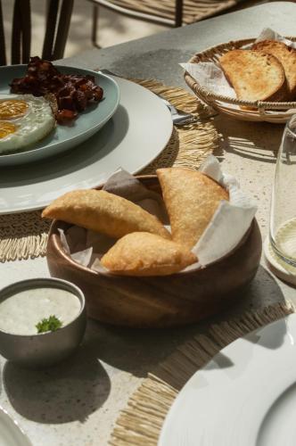 a table with a plate of food with bread and dip at Laguna By LD in El Roque