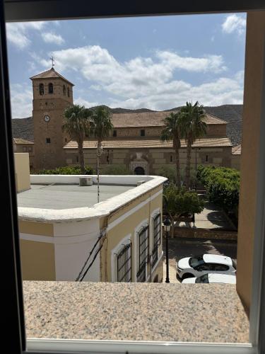 a view from a window of a building with a clock tower at Hostal Avenida in Tabernas