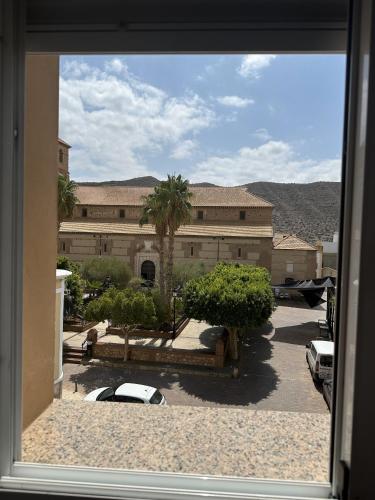 a view of a building with a car parked in a parking lot at Hostal Avenida in Tabernas