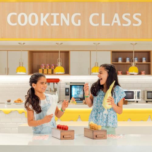 two women standing in front of a counter in a store at Hard Rock Hotel & Casino Punta Cana - All Inclusive in Punta Cana