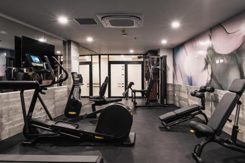 a gym with several tread machines in a room at Wyndham Garden Mazatlan Marina in Mazatlán