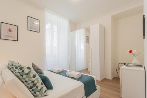 a white room with a bed and a window at ManaraQuattro - apartament in Como near the center with free parking - Lake Como in Como