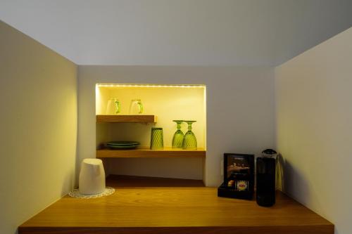 a room with a shelf with vases on it at Keti Hotel in Fira