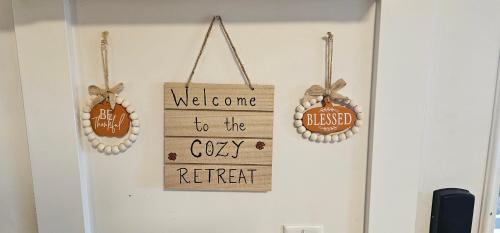 a welcome to the cozy retreat sign on a wall at Cozy Retreat in Mission City