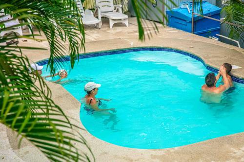 a group of people in a swimming pool at HOTEL, VILLAS y GLAMPINGS MYA -PUERTO VIEJO, Limon, CR in Puerto Viejo