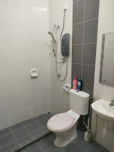 a bathroom with a shower and a toilet and a sink at Dhiyaa's Homestay, Belleza in Jitra