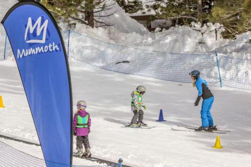 a group of three people skiing in the snow at Mountainback 47 in Mammoth Lakes