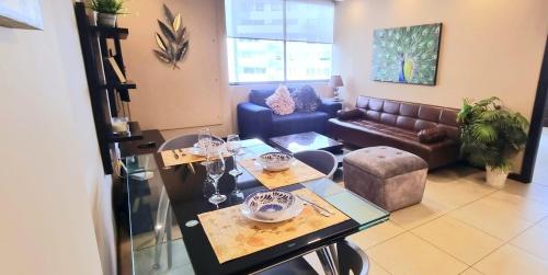 a living room with a couch and a table at Suite Luxury en Puerto Santana in Guayaquil