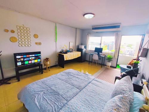 a bedroom with a bed and a tv in it at stay in style at nimman in Chiang Mai