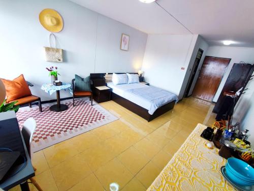 a room with a bed and a couch and a table at stay in style at nimman in Chiang Mai