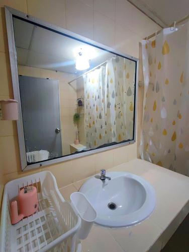 a bathroom with a sink and a large mirror at stay in style at nimman in Chiang Mai