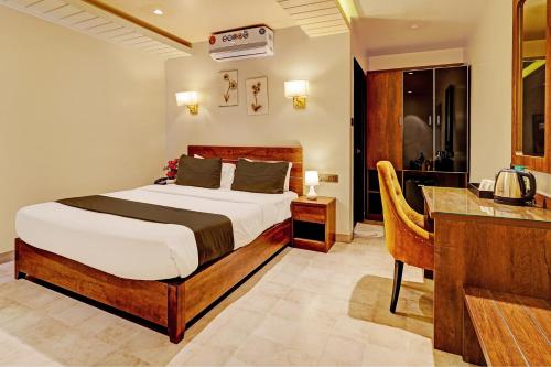 a bedroom with a bed and a desk with a telephone at Super Townhouse OAK Clove Boutique Hotel Rajaji Nagar Near Lulu Mall Bengaluru in Bengaluru