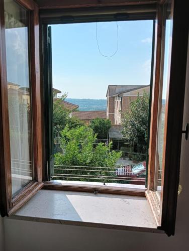 an open window with a view of a city at la casetta toscana in Peccioli