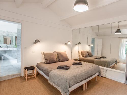 une chambre avec un lit et un grand miroir dans l'établissement Little butterfly, à Lorgues