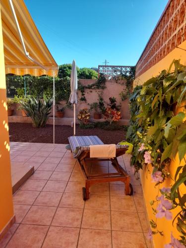 a patio with an umbrella and a chair and an umbrella at Bungalow Heike 2 (Only Adults) in Valle Gran Rey