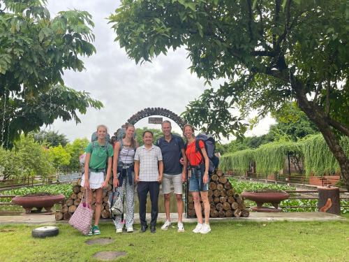 a group of people standing in front of a sculpture at Hoa Lu Garden Resort in Ninh Binh