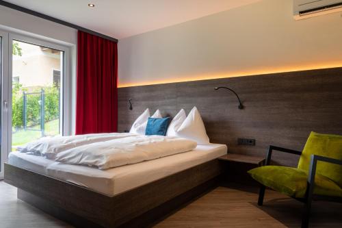 a bedroom with a bed with a red curtain at Freiraum 9 Living Apartment in Sankt Johann im Pongau