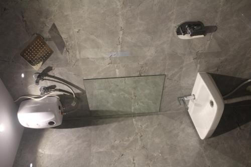 a bathroom with a sink and a mirror at Hotel Metro Inn in Mumbai
