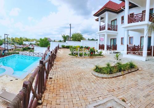a villa with a swimming pool and a house at Villa Alpha in Gulioni