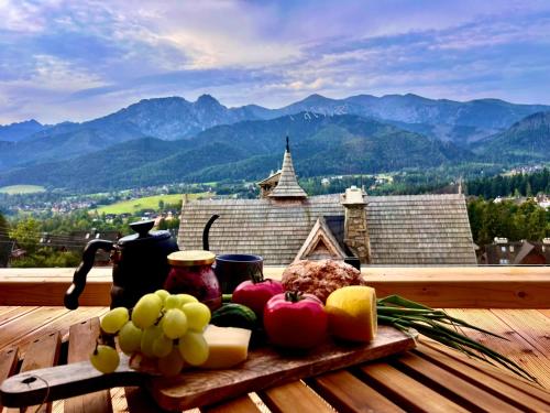 a tray of fruit and vegetables on a wooden table at Schronisko Zmysłów - Apartament 6 in Kościelisko