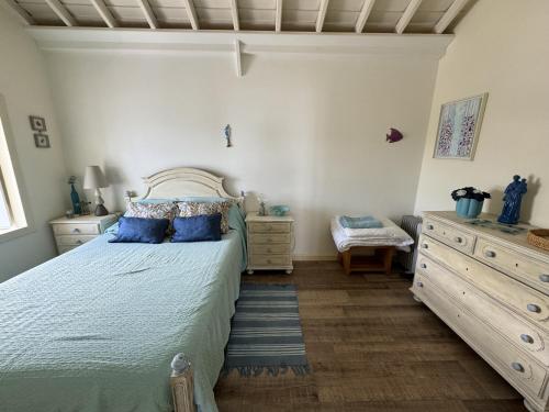 a bedroom with a large bed with blue pillows at Casa da Cisterna in São João