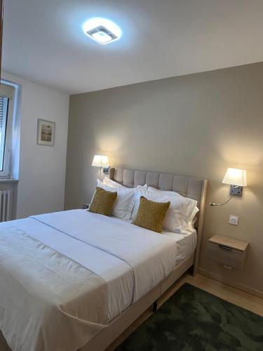a bedroom with a large white bed with two pillows at AppartHôtel Elite Spa in Forbach