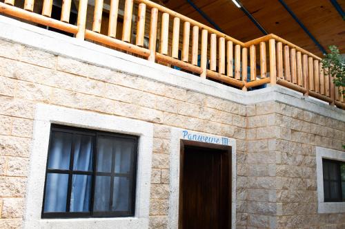 a wooden balcony on top of a brick building at Cabañas Bungalos las Alazanas in San Antonio de las Alzanas