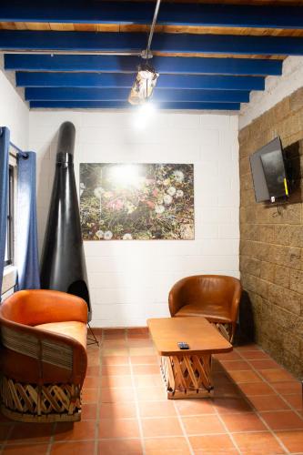 a living room with a couch and a table at Cabañas Bungalos las Alazanas in San Antonio de las Alzanas