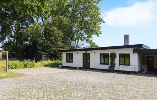 a small white building with a bench in front of it at Cozy Home In Sydals With Sauna in Sarup
