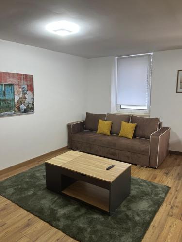 a living room with a couch and a coffee table at AppartHôtel Elite Spa in Forbach