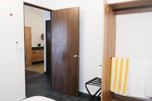 a hallway with a door leading to a kitchen at Quiet and Central Setting 2BR 1BA Office in Isla La Piedra
