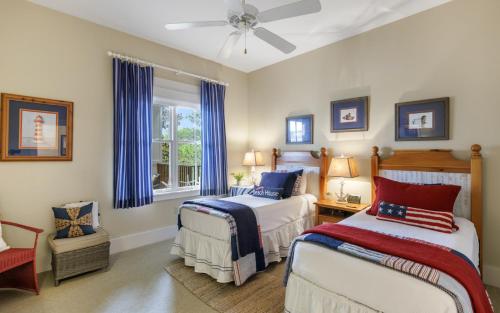 a bedroom with two beds and a ceiling fan at Another Day on 30A by Oversee 30A in Santa Rosa Beach