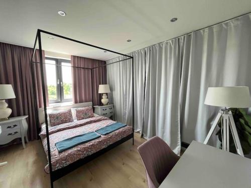 sypialnia z łóżkiem z baldachimem i oknem w obiekcie House in Pezinok with swimming pool, Bratislava w mieście Pezinok