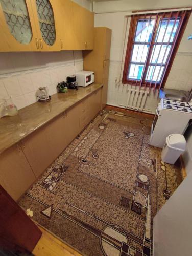 a kitchen with a floor in the middle of a room at Guesthouse Regina in Yaremche