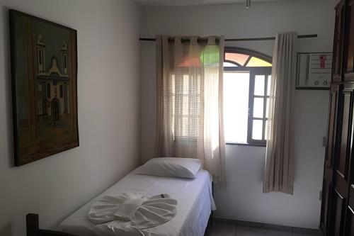 Ένα ή περισσότερα κρεβάτια σε δωμάτιο στο Casa de Praia - Vá a pé pra praia!