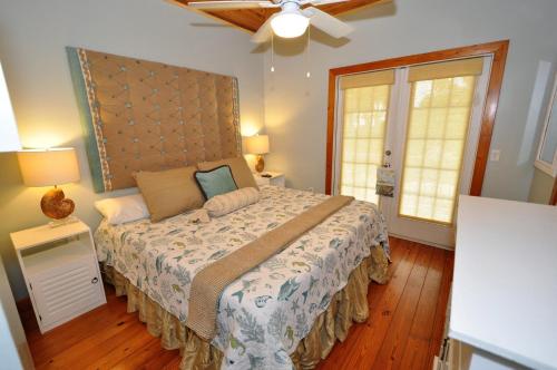 a bedroom with a large bed with a large headboard at Blackbeard`s Hideaway in Key West