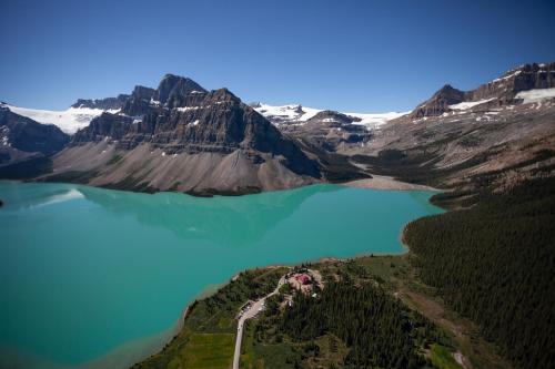 an aerial view of a lake in the mountains at The Lodge at Bow Lake in Lake Louise