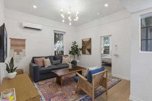 a living room with a couch and a table at Cozy 1 BR Casita Overflowing with Natural Light in San Diego