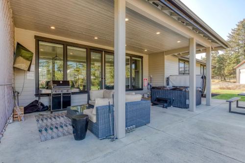 a screened in porch of a house with a patio at Gearhart Getaway - Gated Community Home w/ Hot Tub, Walk to Beach in Warrenton
