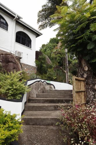 a set of stairs in front of a house at The Salty Palms in Beau Vallon