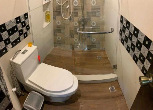a bathroom with a toilet and a shower at Tagum Mini Hotel By Tripleview residences in Tagum