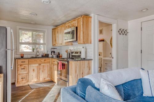 a kitchen with wooden cabinets and a blue couch at Riverbend Cabin 1 - Lolo Bungalow in Rhododendron