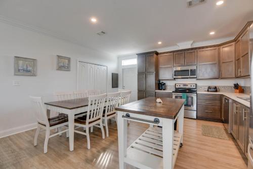 a kitchen with wooden cabinets and a table and chairs at Paradise Found in Key West