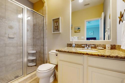 a bathroom with a toilet and a shower and a sink at Garden Breeze Condominiums #3 in South Padre Island