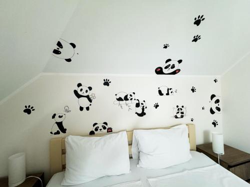 a bedroom with panda animals on the wall at SIGNEEV'S Villa in Kyiv